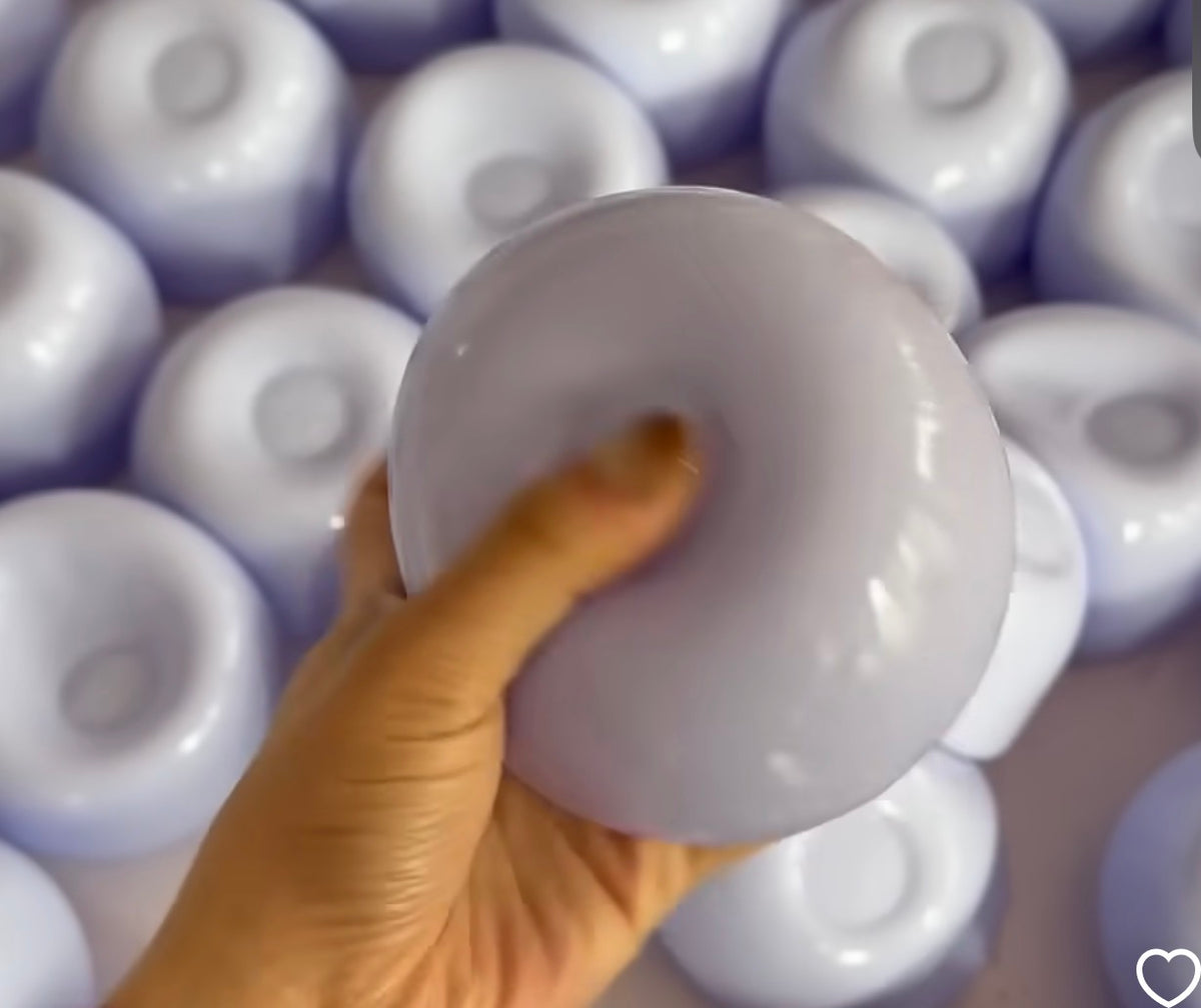 Jumbo white smooth ball squishy fidget toy being pressed by hand