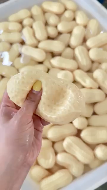 Peanut pebble texture squishy fidget toy pressed in one hand