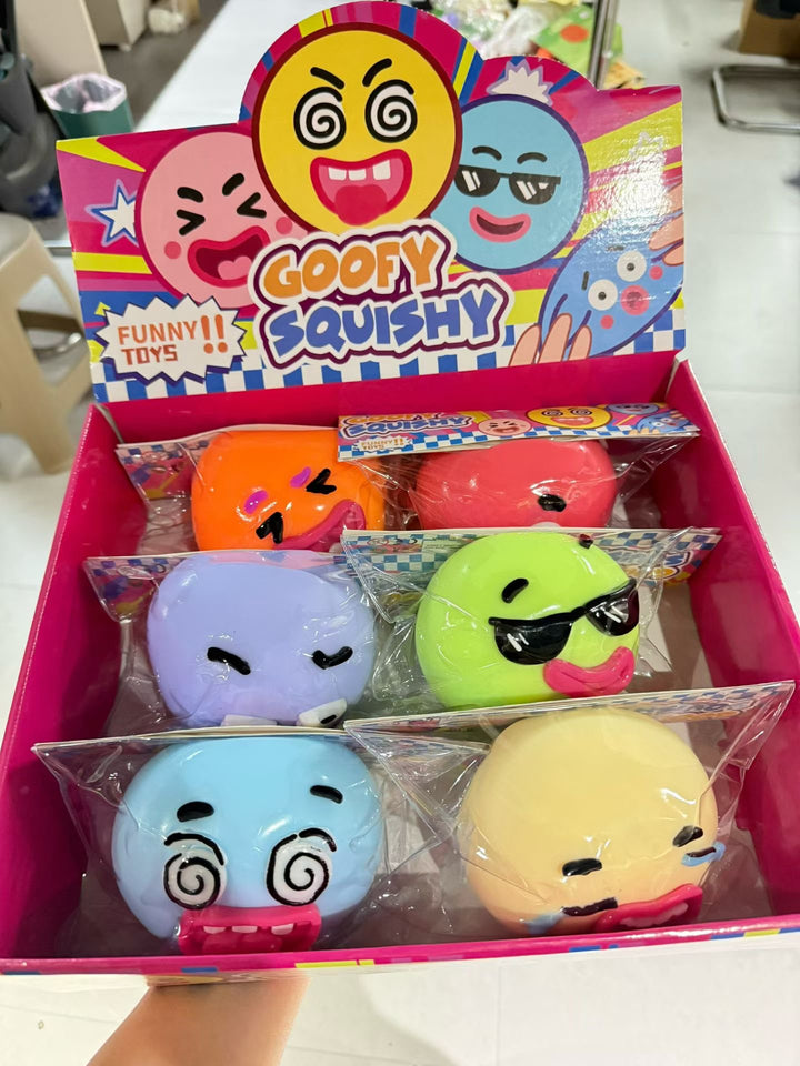 Assorted colorful goofy face character squishy fidget toys in a display box