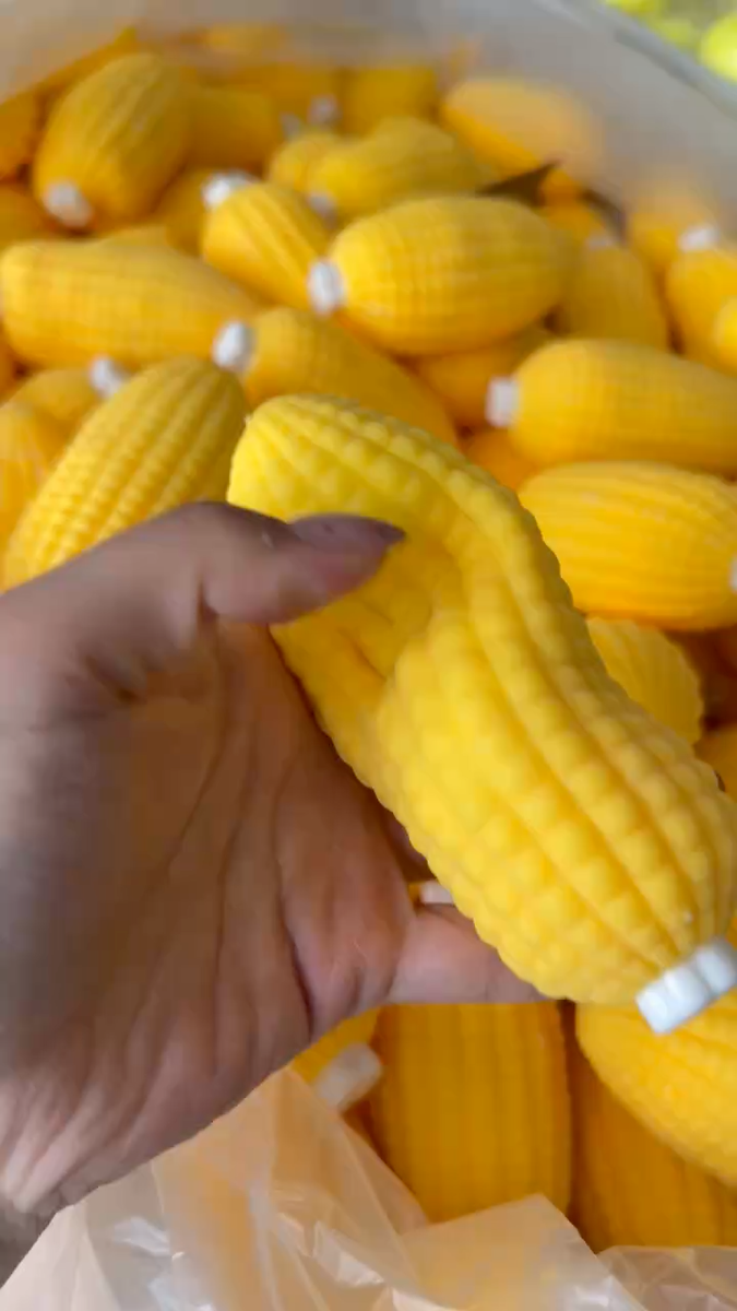 Textured corn cob squishy fidget toy bent in one hand