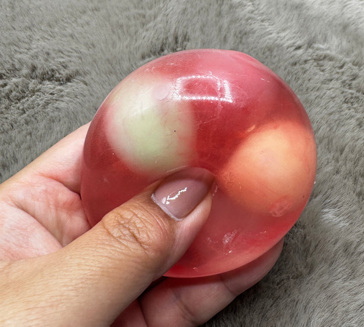 Cotton Candy pink wax-cracking stress ball with pastel inserts