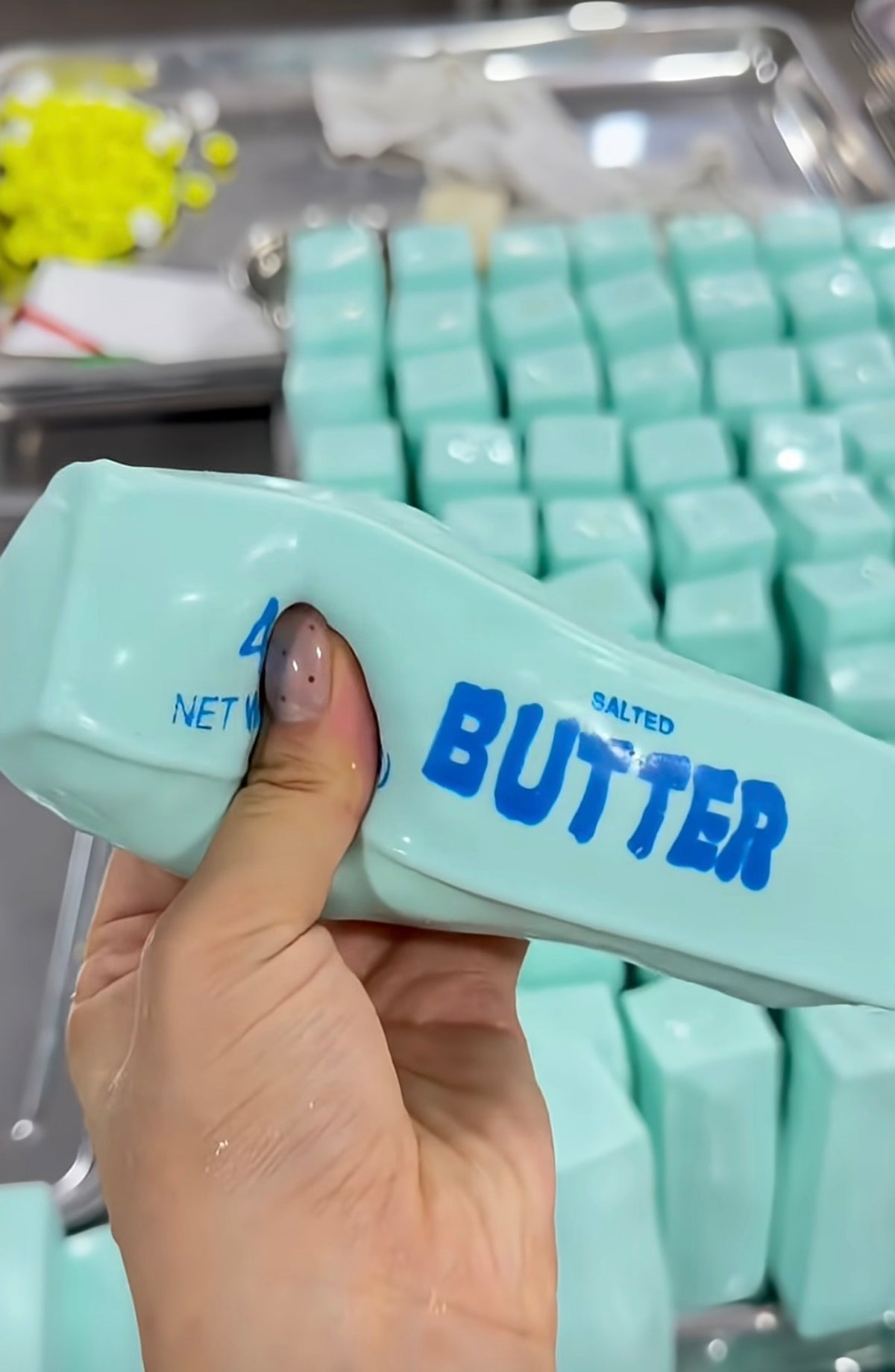 Blue crunchy butter squishy pressed by hand beside textured filling