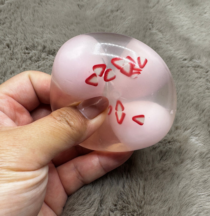 Strawberry Milk pink wax-cracking stress ball with strawberry slice decorations